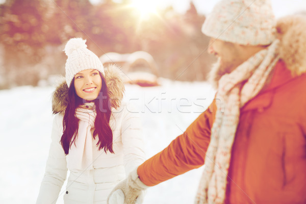 happy couple walking along snowy winter field Stock photo © dolgachov