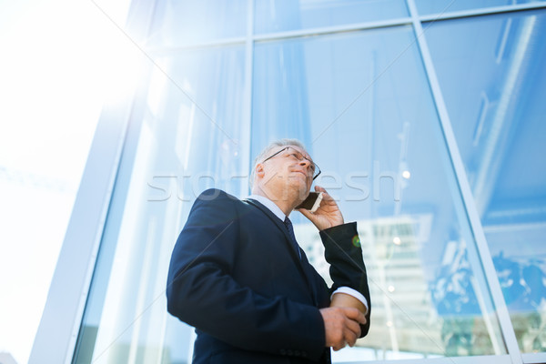 senior businessman calling on smartphone in city Stock photo © dolgachov