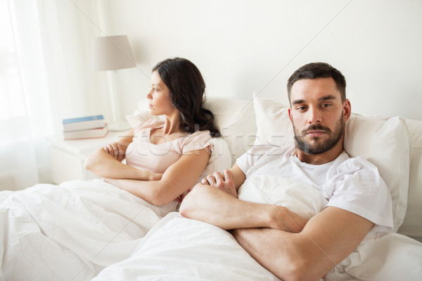 unhappy couple having conflict in bed at home Stock photo © dolgachov