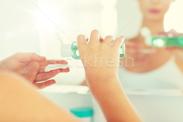 young woman with lotion washing face at bathroom Stock photo © dolgachov