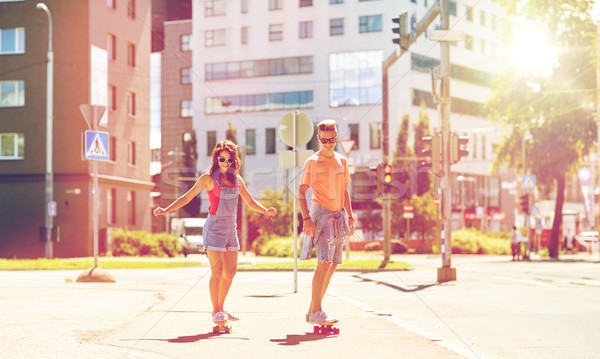 teenage couple riding skateboards on city street Stock photo © dolgachov