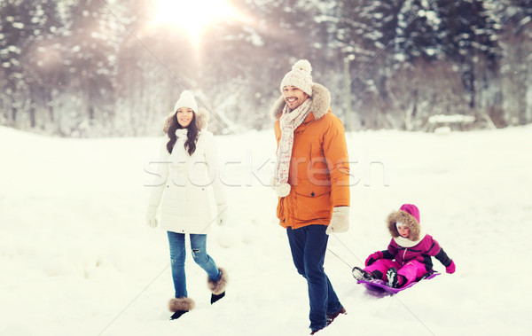 happy family with sled walking in winter forest Stock photo © dolgachov