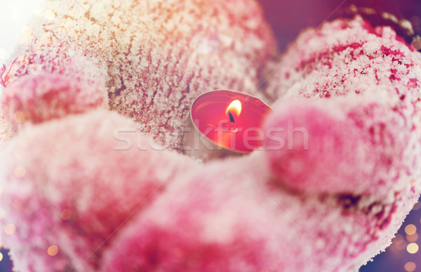 close up of hands in winter mittens holding candle Stock photo © dolgachov