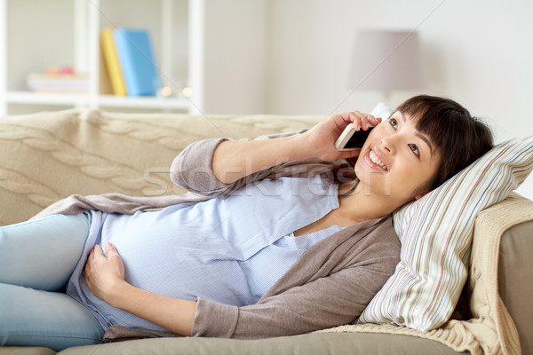 happy pregnant woman calling on smartphone at home Stock photo © dolgachov