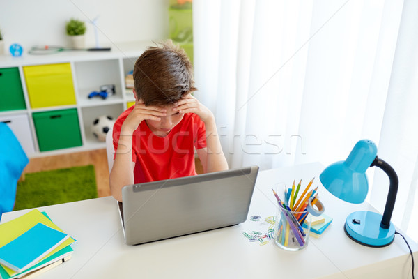 tired student boy with laptop computer at home Stock photo © dolgachov