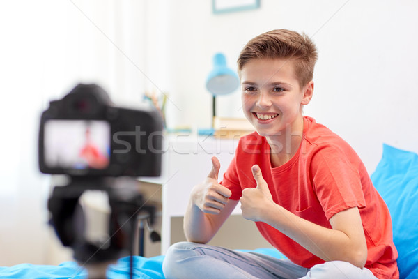 happy boy with camera recording video at home Stock photo © dolgachov