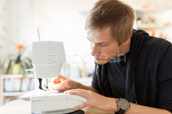 fashion designer with sewing machine at studio Stock photo © dolgachov