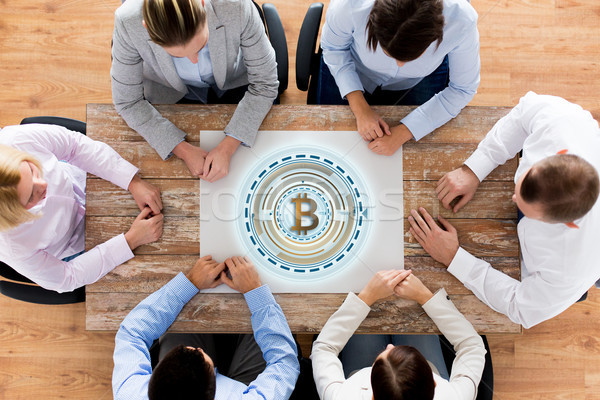 business team at table with bitcoin icon Stock photo © dolgachov