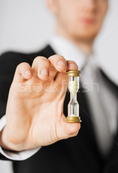 Stock photo: man hand holding hourglass