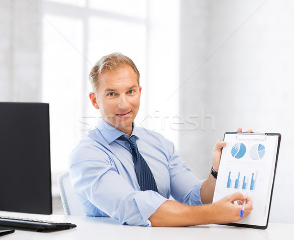 businessman showing graphs and charts Stock photo © dolgachov