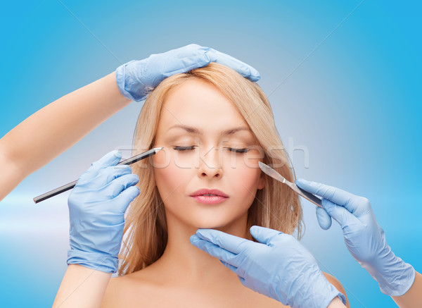 woman and beautician hands with pencil and scalpel Stock photo © dolgachov