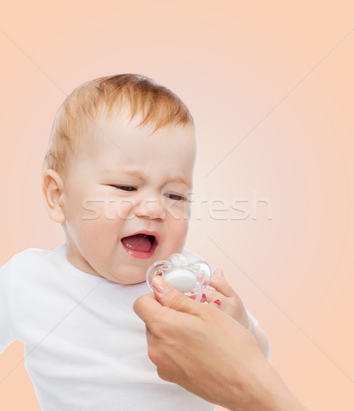 crying baby with dummy Stock photo © dolgachov