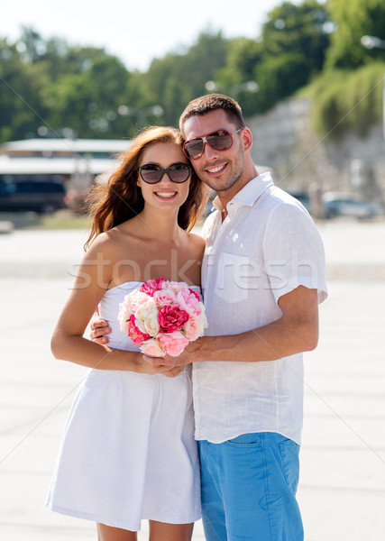 smiling couple in city Stock photo © dolgachov