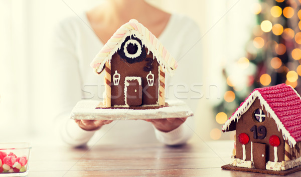 close up of woman showing gingerbread house Stock photo © dolgachov