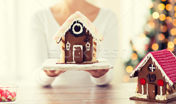 close up of woman showing gingerbread house Stock photo © dolgachov