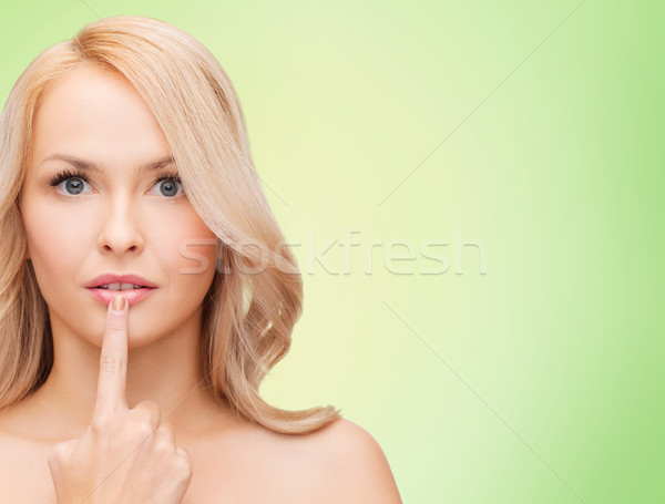 beautiful young woman touching her lips Stock photo © dolgachov