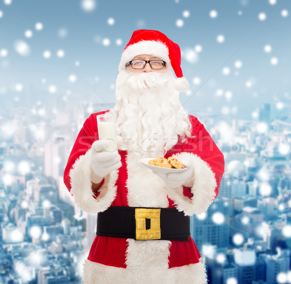 Stock photo: santa claus with glass of milk and cookies