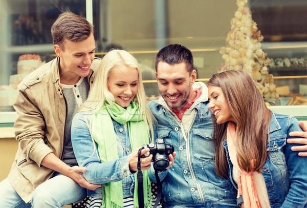 group of smiling friends with digital photocamera Stock photo © dolgachov