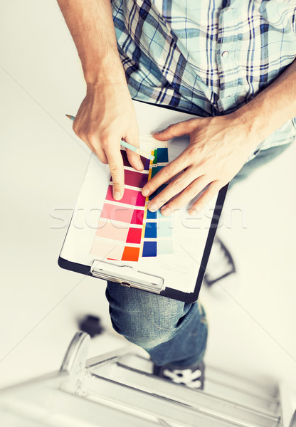 man with color samples for selection Stock photo © dolgachov