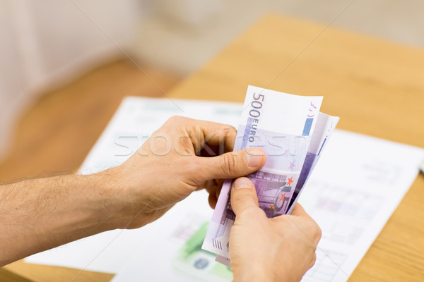 Közelkép férfi kezek pénz otthon megtakarított pénz Stock fotó © dolgachov