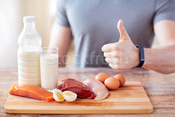 man with food  rich in protein showing thumbs up Stock photo © dolgachov