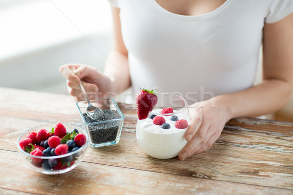 close up of woman hands with yogurt and berries Stock photo © dolgachov