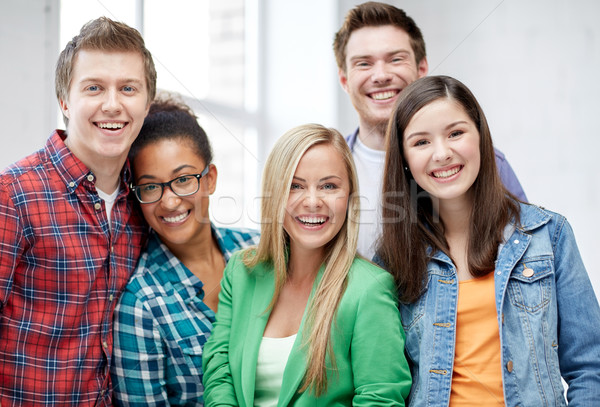 group of happy high school students or classmates Stock photo © dolgachov