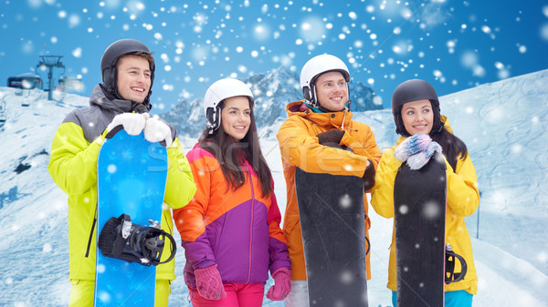 happy friends with snowboards over mountains Stock photo © dolgachov