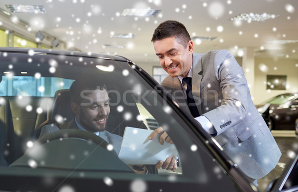 happy man with car dealer in auto show or salon Stock photo © dolgachov