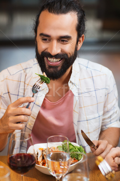 Stock photo: happy man having dinner at restaurant