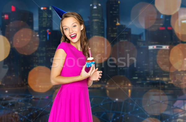 happy woman with birthday cupcake over night city  Stock photo © dolgachov