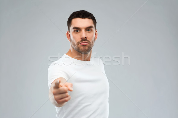 angry man pointing finger to you over gray Stock photo © dolgachov