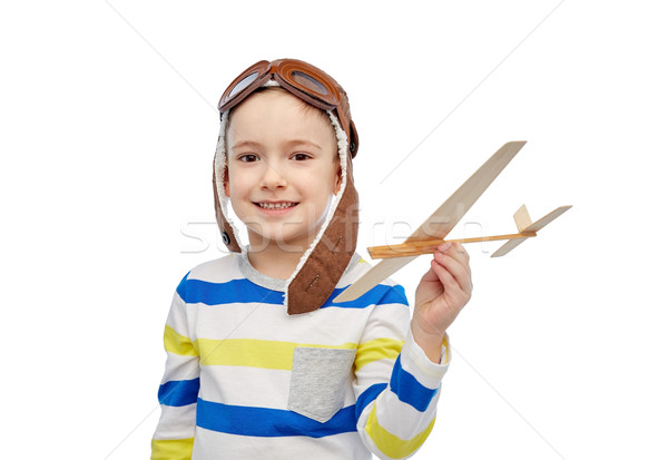 Stock photo: happy little boy in aviator hat with airplane