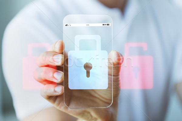 close up of hand with security lock on smartphone Stock photo © dolgachov