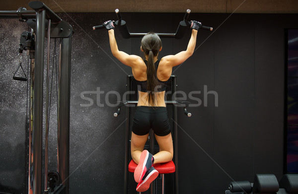 woman exercising and doing pull-ups in gym Stock photo © dolgachov