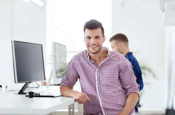 happy creative man with computer at office Stock photo © dolgachov