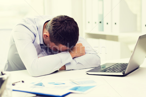 businessman with laptop and papers in office Stock photo © dolgachov