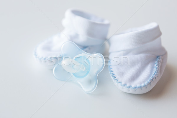 close up of baby bootees and soother for newborn Stock photo © dolgachov