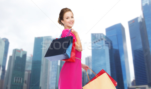 happy woman with shopping bags over singapore city Stock photo © dolgachov