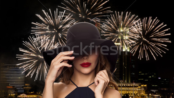 beautiful woman in black hat over night firework Stock photo © dolgachov