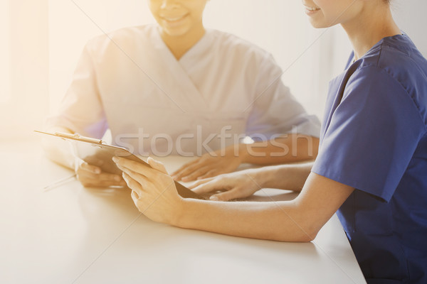 Stock photo: close up of doctors with clipboard at hospital