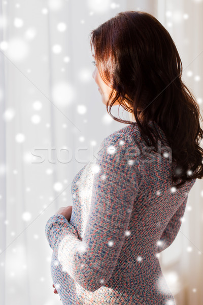 close up of happy pregnant woman looking to window Stock photo © dolgachov