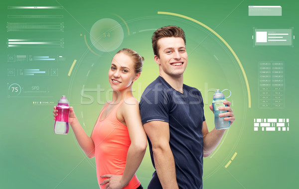 sportive man and woman with water bottles Stock photo © dolgachov