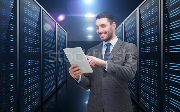 businessman with tablet pc over server room Stock photo © dolgachov