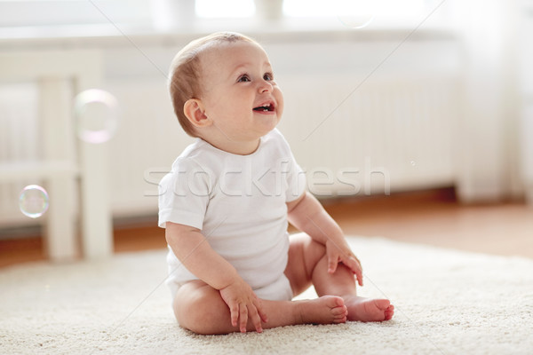 happy baby with soap bubbles at home Stock photo © dolgachov
