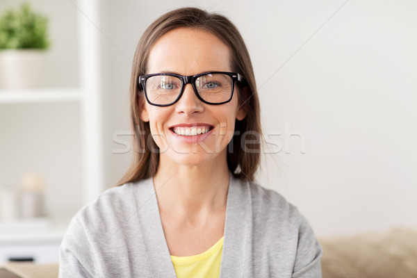 happy smiling middle aged woman in glasses at home Stock photo © dolgachov