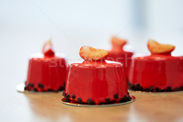 Stock photo: strawberry mirror glaze cakes at pastry shop
