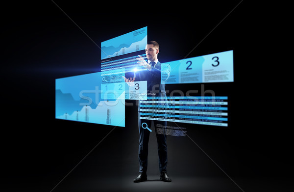 businessman with stock charts on virtual screens Stock photo © dolgachov