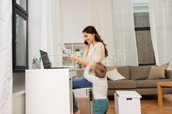 happy mother with baby and papers working at home Stock photo © dolgachov