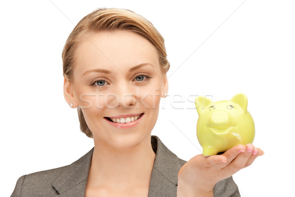 Stock photo: lovely woman with piggy bank